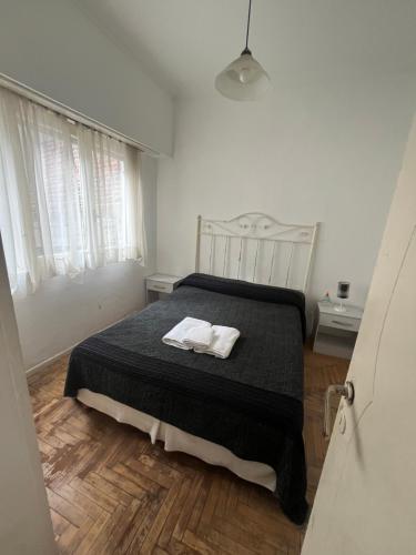 a bedroom with a bed with two towels on it at Departamento 2 amb centro in Mar del Plata