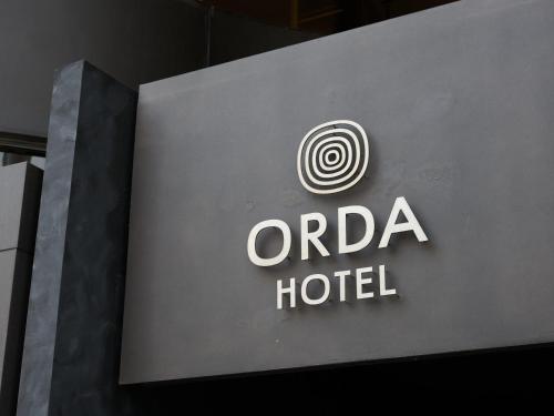 a sign for an oraria hotel on a building at ORDA HOTEL in Chiba