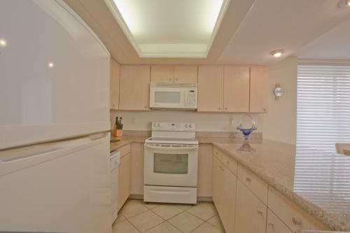 a kitchen with a stove and a microwave at Sea Vista in South Padre Island