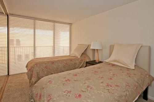 a bedroom with two beds next to a window at Sea Vista in South Padre Island