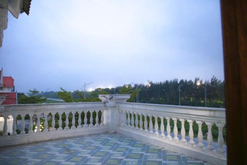 a balcony with a white railing and a view of the city at Cua Lo Beach Villa 1 in Giáp Vinh Yên