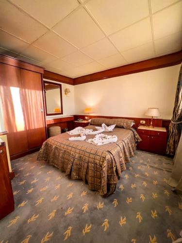 a hotel room with a bed in a room at nile cruise king boat in Cairo