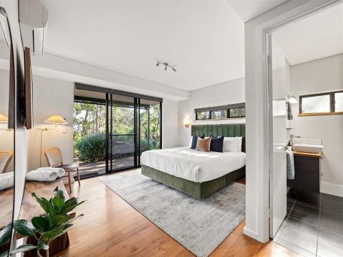 a bedroom with a bed and a large window at Wildflower Ridge in Yallingup
