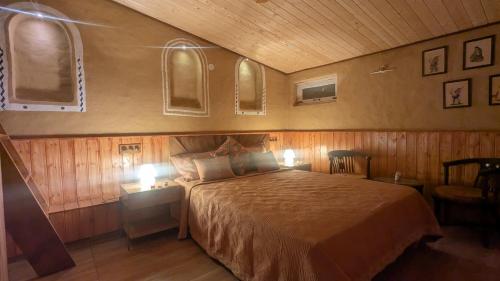 a bedroom with a bed with two lights on it at Quaint village farm stay in Kangra