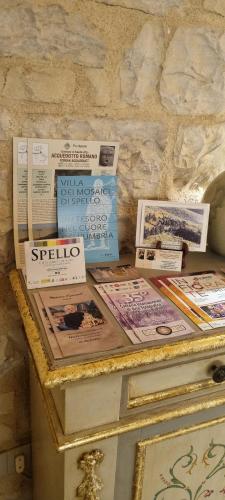 a table with magazines and books on top of it at Domus Hispellum in Spello