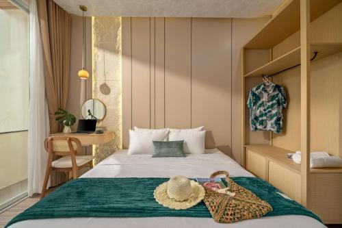 a bedroom with a bed with a hat on it at Kochi House, brand new 4BDR, 850m to the beach in Da Nang
