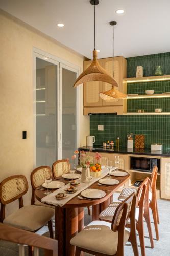 a kitchen with a large wooden table and chairs at Kochi House, brand new 4BDR, 850m to the beach in Da Nang