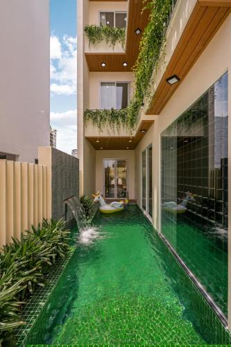 an infinity pool in a house with people in bath tubs at Kochi House, brand new 4BDR, 850m to the beach in Da Nang