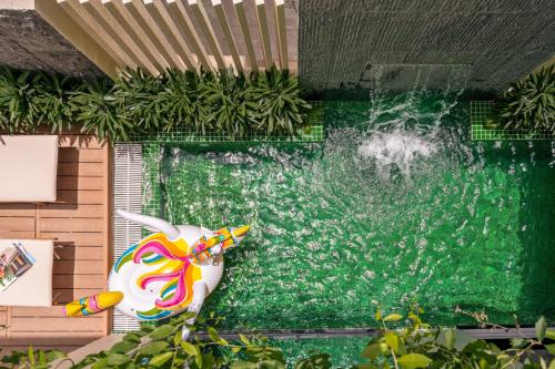 a swimming pool with an inflatable flamingo in front at Kochi House, brand new 4BDR, 850m to the beach in Da Nang