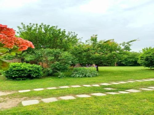 a group of people sitting on a bench in a park at Apartment near Cremona in Historic Convent in Stagno Lombardo