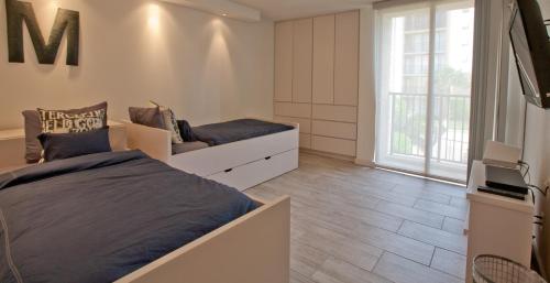 a bedroom with a bed and a couch and a tv at Sea Vista in South Padre Island