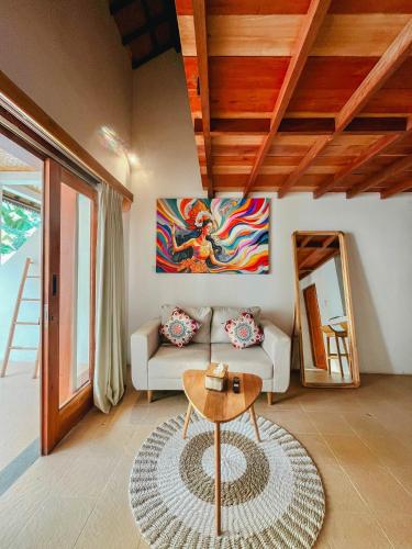 a living room with a couch and a table at RATU Village - Luxury Apartement & Beachfront Villa Gili Air in Gili Air