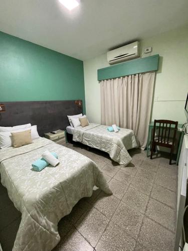 a hotel room with two beds and a window at HOTEL JUAN b JUSTO GARDEN in Mendoza