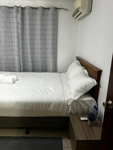a bed with white sheets and pillows in a room at Easy Apartment- 36 Varani street flat 3&flat 6 in Suva
