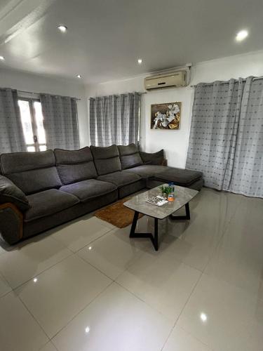 a living room with a couch and a table at Easy Apartment- 36 Varani street flat 3&flat 6 in Suva