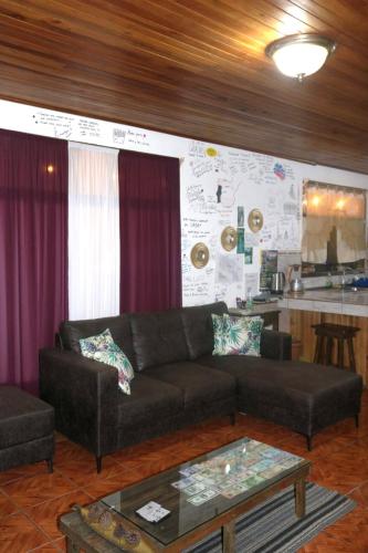 a living room with a couch and a table at Twin Palms house in Monteverde Costa Rica