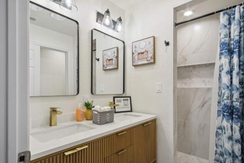 a bathroom with a sink and a mirror at Your Amazing 3BR2BA Downtown Delight in San Antonio