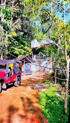 a small vehicle parked in front of a building at Green porticos villa munnar #MUNNAR in Anachal