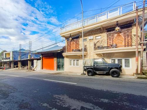 a black truck parked in front of a building at MAHA LIVING Dieng Syariah RedPartner in Dieng
