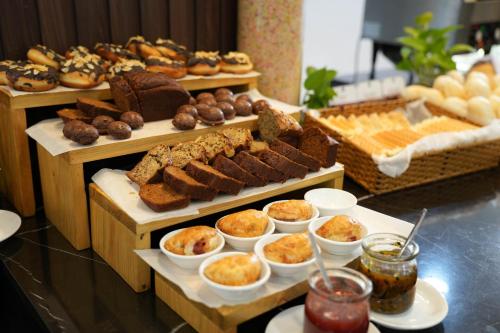 a buffet of different types of bread and pastries at Hoang Long Hotel Phan Thiết in Phan Thiet