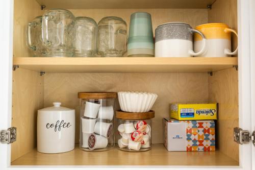 a shelf with cups and other items on it at Stylish Condo in Village Oak Creek with Pool and Hot Tubs in Sedona