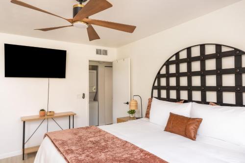 a bedroom with a large bed with a ceiling fan at Stylish Condo in Village Oak Creek with Pool and Hot Tubs in Sedona