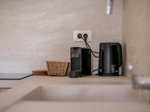 a kitchen counter with two appliances sitting on a shelf at Sunset apartments Njivice in Njivice