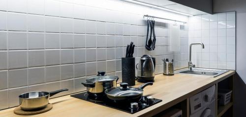a kitchen with two pots and pans on a stove at Loft студія в Аркадіі з шикарним видом города in Odesa