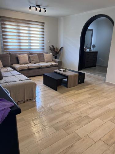 a living room with a couch and a table at Demi's Apartments Near Athen's Airport in Artemida