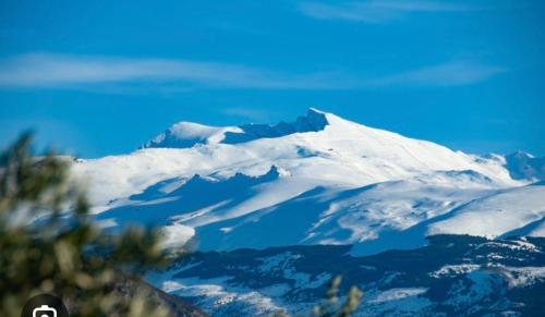a mountain with snow on top of it at Encarnita Apartamento - Monachil in Monachil