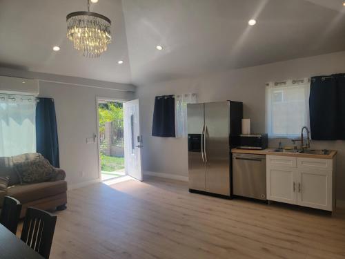 a kitchen with a stainless steel refrigerator and a couch at Casa One in Winnetka