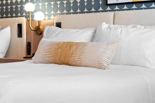 a white bed with a pillow on top of it at Star Motel in San Francisco