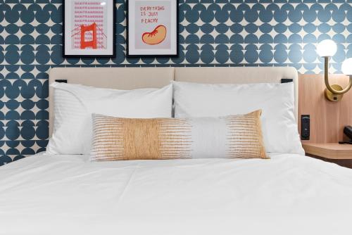 a bedroom with a white bed with two pictures on the wall at Star Motel in San Francisco