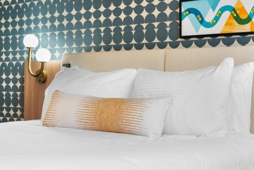 a white bed with white pillows in a hotel room at Star Motel in San Francisco