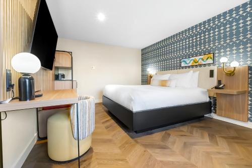 a hotel room with a bed and a desk at Star Motel in San Francisco