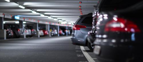 a row of parked cars in a parking garage at Savoy Central Hotel Apartments in Dubai