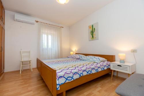 a bedroom with a bed and a table and a chair at Haus Valerija in Labin