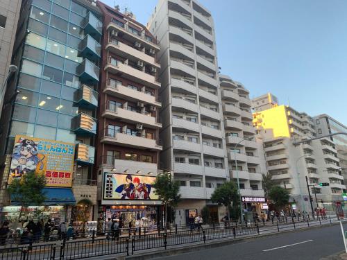 a tall building on a street in a city at Sunshine Grand Hotel Ikebukuro in Tokyo