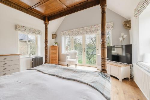 a bedroom with a large bed and large windows at Inkerman House - Gorgeous House and Gardens in Fritwell