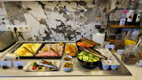 a buffet with many different types of food on a counter at Suncity Hotel & SPA in Šiauliai