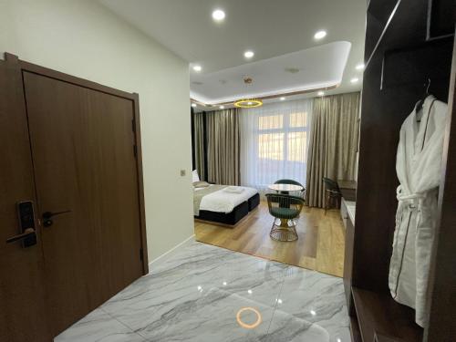 a hotel room with a bed and a door at Numt Guren Resort in Ulaanbaatar