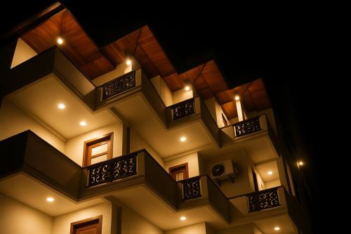 a building with balconies and lights on it at Ranaya Residence Kandy in Kandy