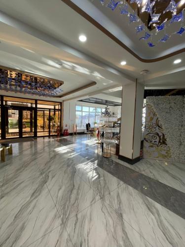 a lobby with a marble floor and a ceiling at Numt Guren Resort in Ulaanbaatar