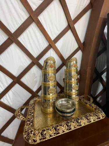 a gold tray with two candles on a table at Numt Guren Resort in Ulaanbaatar