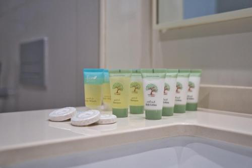 a group of products sitting on a bathroom counter at Coastal Bliss 1BHK Sea View Apartment by Czechin in Ras al Khaimah