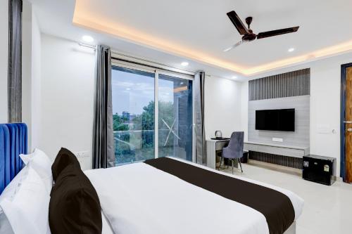 a bedroom with a bed and a large window at The Byke Business Hotel - Sector 29 in Gurgaon