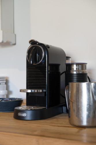 a coffee maker sitting on top of a table at Serenity in Red Hill - Winery Bliss & Coastal Beauty in Red Hill South