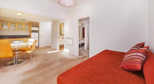 a bedroom with a bed and a table and a kitchen at Wairakei Resort Taupo in Taupo