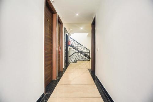 a hallway with white walls and a stairway at Super Collection O Amritsar Near Railway Station in Amritsar