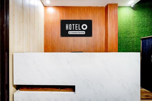 a hotel room with a sign on the wall at Hotel O Rajeev Nagar Faridabad in Faridabad